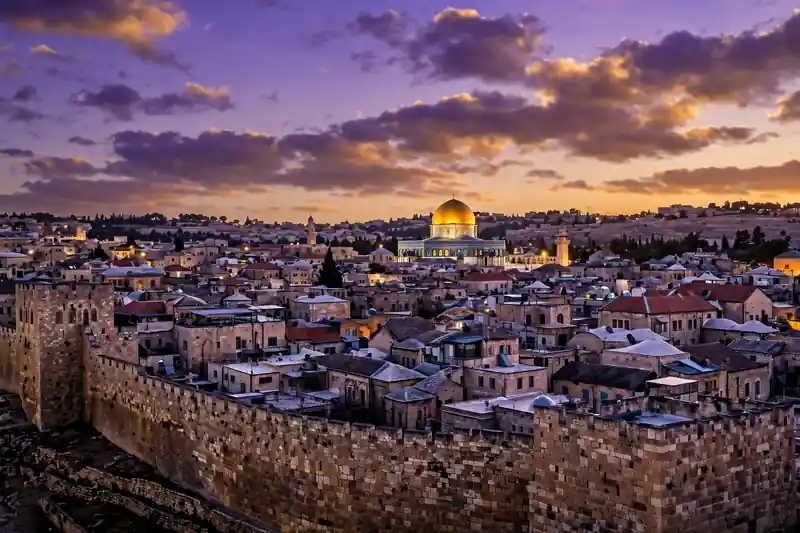 Jerusalem's old city skyline glowing at dusk during the High Holidays